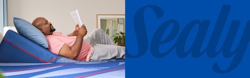 A man reading on a Posturepedic Elite mattress