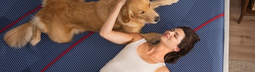 woman and her dog on a posutepedic mattress