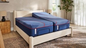 A Split Posturepedic Elite Hybrid mattress on an adjustable base with one side in an elevated position