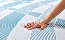 Hand pressing into Dreamlife Mattress