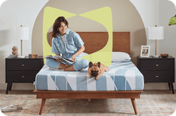 Woman lounging on Dreamlife mattress with her dog