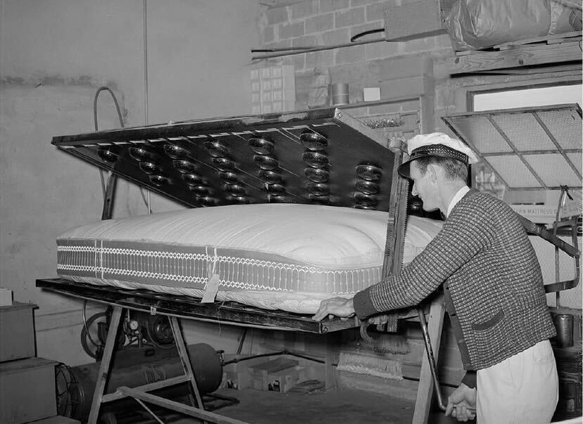 Historical photo of 1880's worker making mattress in sealy texas