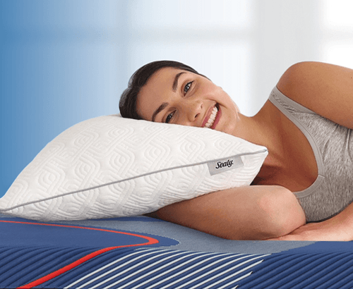 Woman laying on a Sealy adjustable pillow with blue gradient background