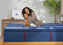 Woman and child sitting on a Elite spring mattress with a pillow top - mobile flipped