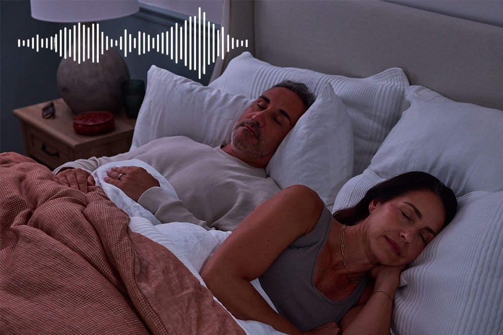 couple sleeping with a sound machine
